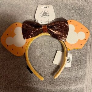 Disney Beige Headband with Blue Logo Plate